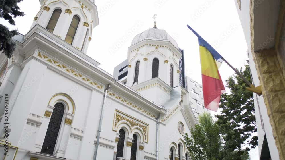 Romania flag in front of an orthodox church Romania flag in front of an orthodox church