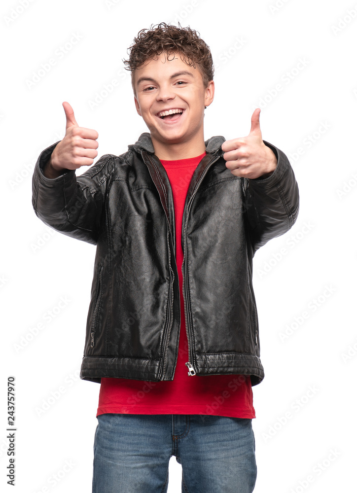 Portrait of a Handsome brutal Teen Boy in a black Leather Jacket. Smiling fashion Child Model isolated on a white background. Funny Teenager making Thumbs Up Gesture. Portrait of a Handsome brutal Teen Boy in a black Leather Jacket. Smiling fashion Child Model isolated on a white background. Funny Teenager making Thumbs Up Gesture.