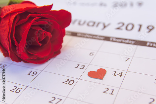 Valentines day. Red rose and red hearts on Calendar page February 14 with copy space