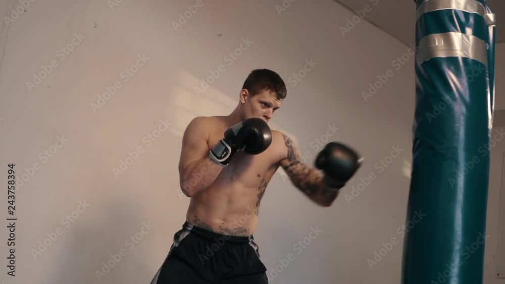 Strong caucasian man boxing using punch sake Strong caucasian man boxing using punch sake