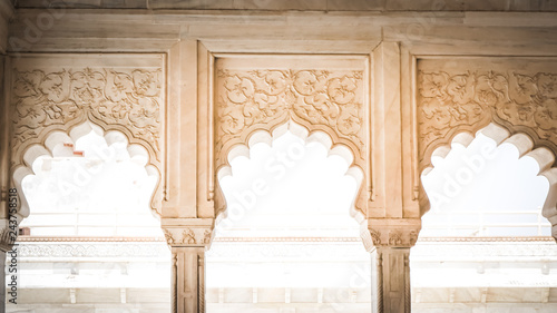 Fototapeta Naklejka Na Ścianę i Meble -  Islamic - Indian white marble columns and arches decorations inside palaces during Mughal empire. White palace exterior decorations at Agra Fort fortress in Agra, India.