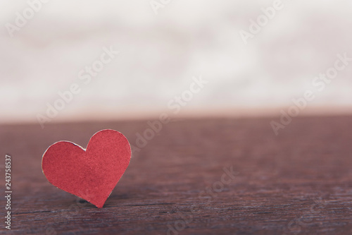 Valentines Day background with red heart shape on dark wooden background with copy space