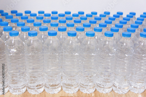 Row of water bottles. Bottles with blue caps For drinking water