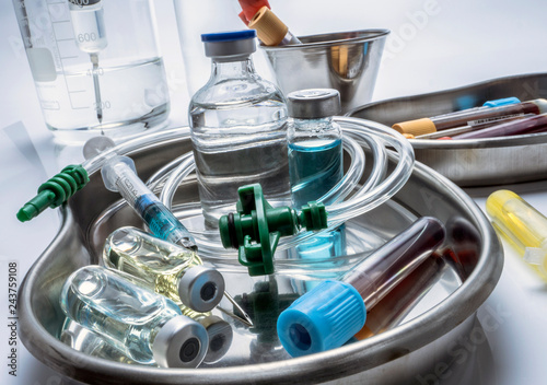 Several vials and blood sample in a metal tray, conceptual image photo