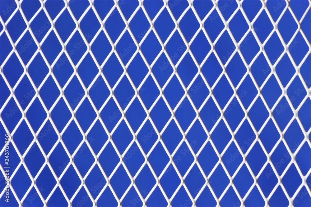 Naklejka premium Metal mesh on a blue abstract background, good for design and creativity of the holiday. Many geometric shapes form a unique pattern, applicable to design and creativity, the art of abstraction.