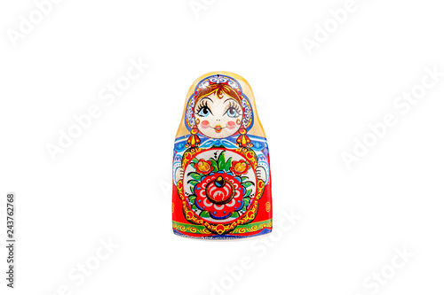 ceramic souvenir toy in the form of matryoshka with beautiful color painting on isolated white background reflecting the national Russian culture