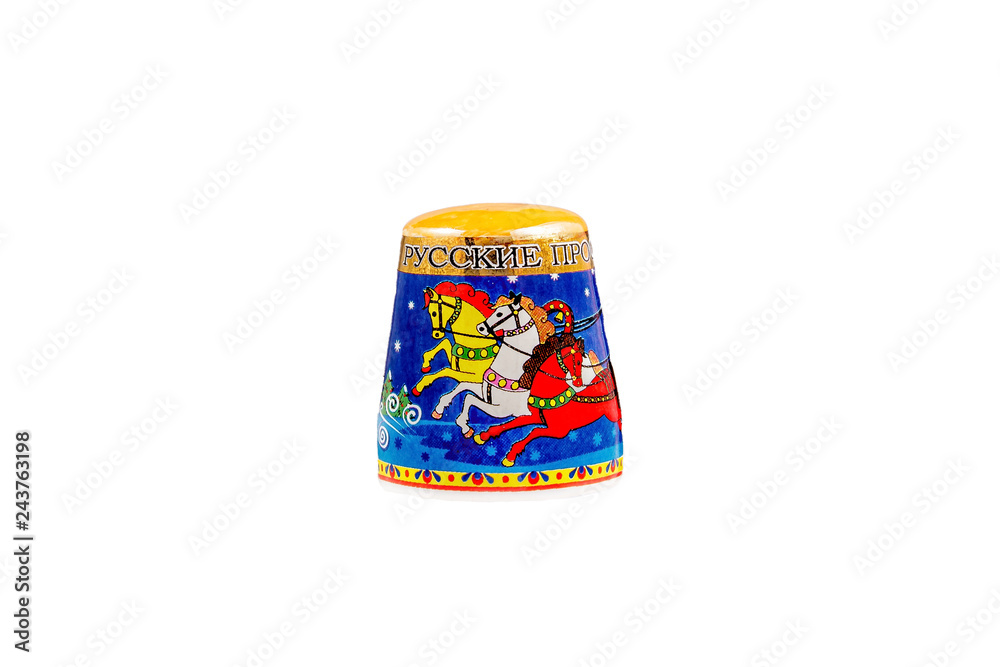 ceramic souvenir toy in the form of thimble with beautiful color painting on isolated white background reflecting the national Russian culture with the inscription in Russian: 