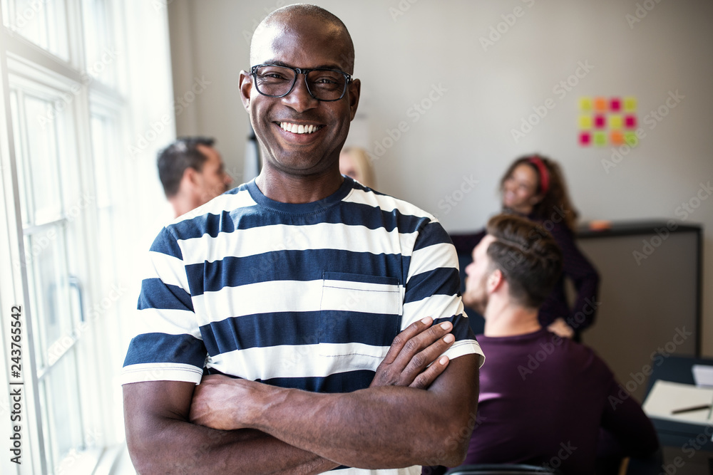 Fototapeta premium African designer smiling confidently after an office meeting