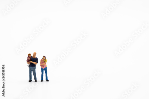 Miniature people, family and children isolated on white background. International Day of Families