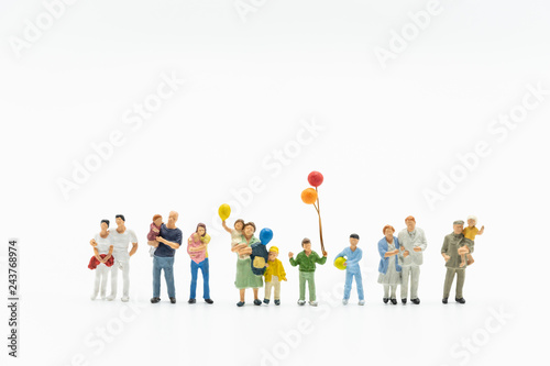 Miniature people, family and children with colorful balloons  standing isolated on white background. International Day of Families