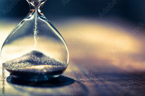 Hourglass as time passing concept for business deadline, urgency and running out of time. Sandglass, egg timer showing the last second or last minute or time out.  With copy space.