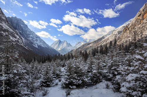 ShuangQiao Valley Scenic Area, Four Girls Mountain National Park in Sichuan Province China. Snow Capped Jagged Mountains with clouds forming at the summit. Blue Sky, Snow Mountains, Siguniangshan
