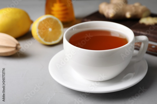 Cup of hot tea and natural cough remedies on table