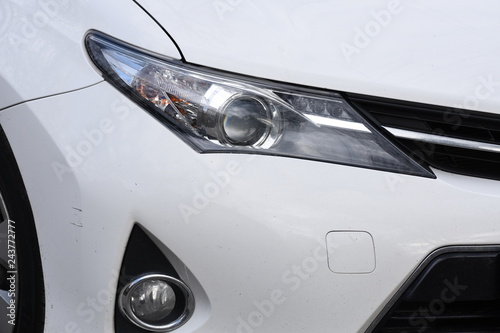 shiny headlights on a white car © Laurenx