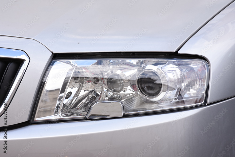 shiny headlights on a silver car shiny headlights on a silver car