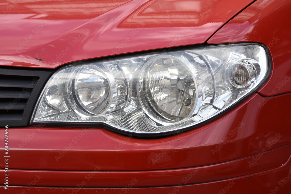 shiny headlights on a red car