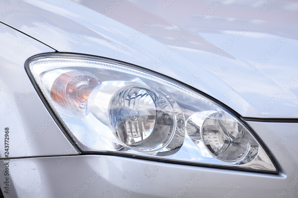 shiny headlights on a silver  car