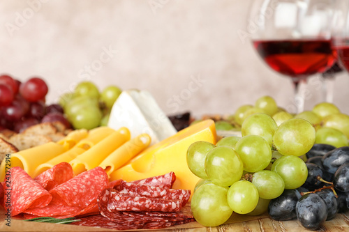Different snacks and blurred glasses of wine on background