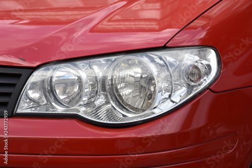 shiny headlights on a red car © Laurenx