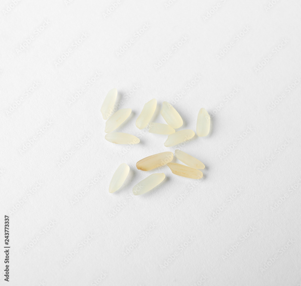 Uncooked parboiled rice on white background, top view Uncooked parboiled rice on white background, top view