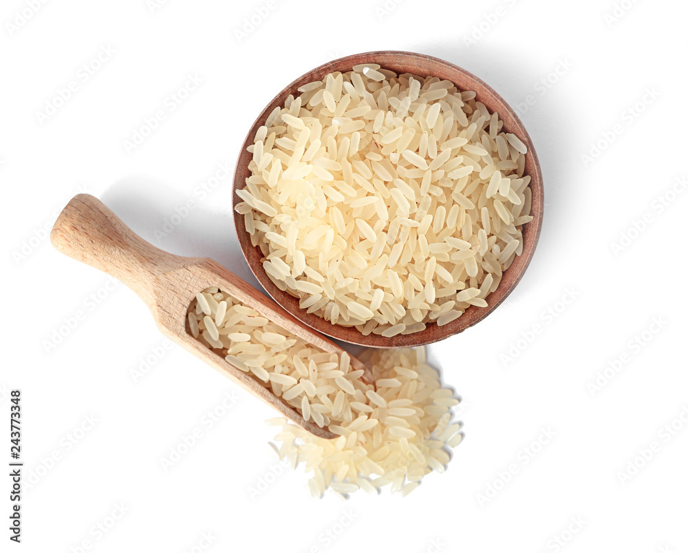 Bowl and scoop with uncooked parboiled rice on white background, top view Bowl and scoop with uncooked parboiled rice on white background, top view