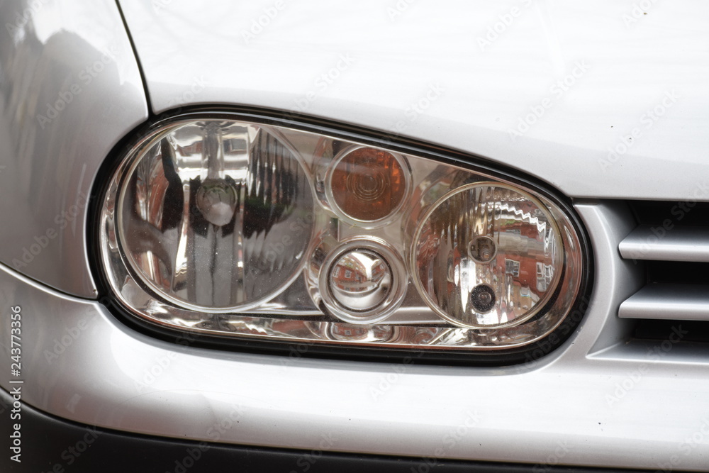 shiny headlights on a silver  car