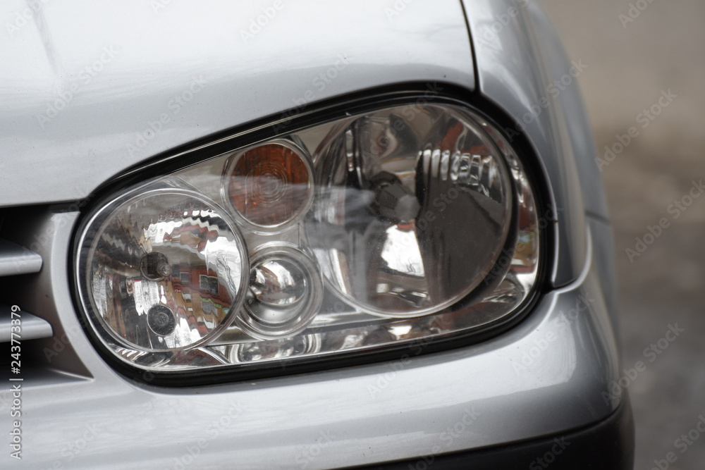 shiny headlights on a silver car shiny headlights on a silver car
