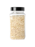 Jar with uncooked brown rice on white background