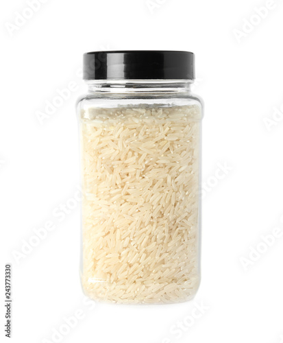 Jar with uncooked long grain rice on white background