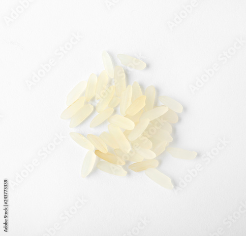 Uncooked parboiled rice on white background, top view