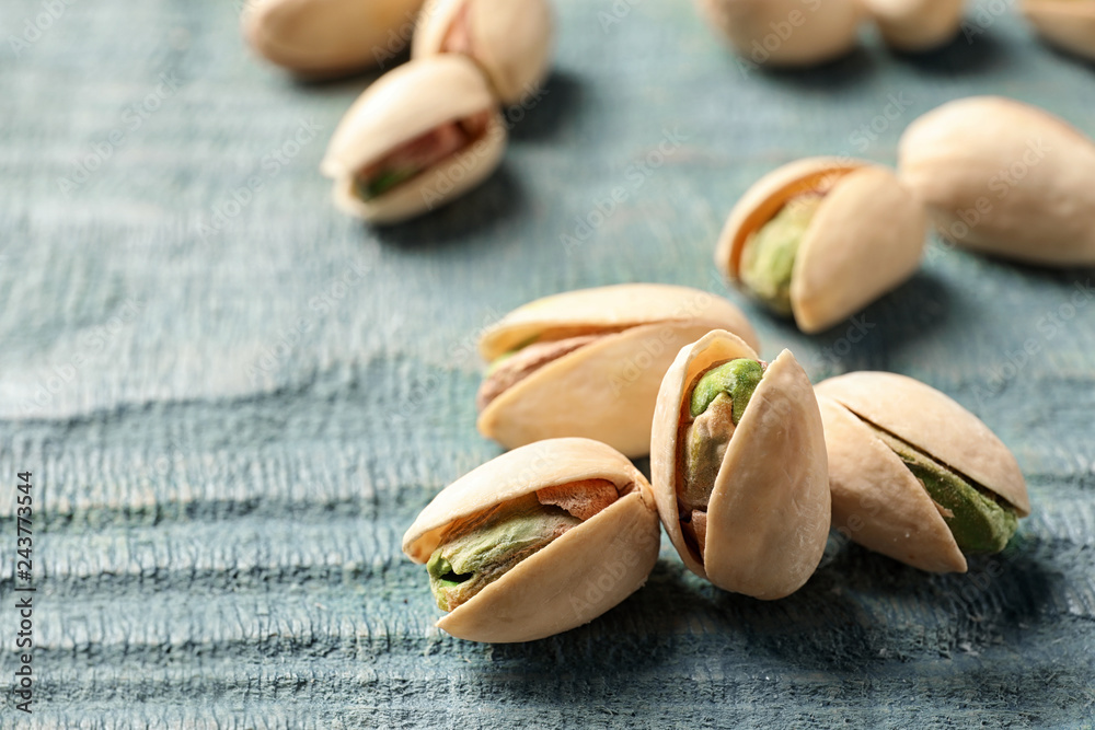 Organic pistachio nuts on wooden table, closeup Organic pistachio nuts on wooden table, closeup