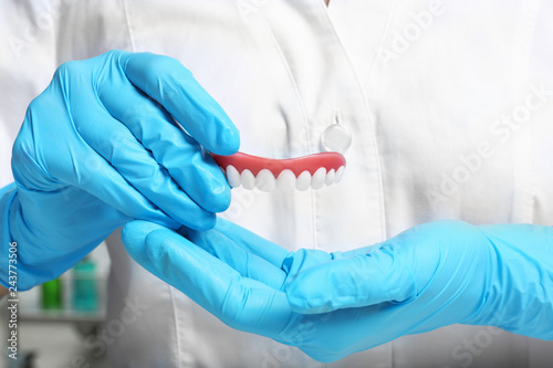 Dentist holding teeth cover, closeup view. Restorative dentistry