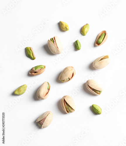 Composition with organic pistachio nuts on white background, top view