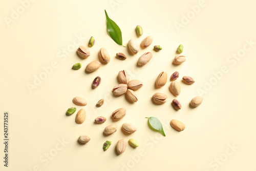 Composition with organic pistachio nuts on color background, flat lay
