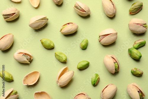 Composition with organic pistachio nuts on color background, flat lay