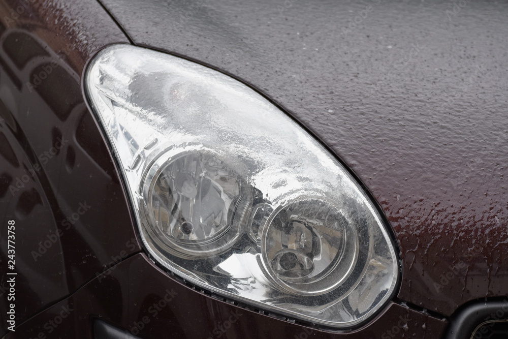  Frozen car headlight,Freezing rain ice coated car. 