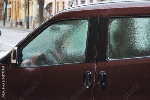 Freezing rain ice coated car,side window and frozen windshield car