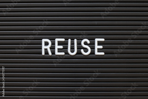 Black color felt letter board with white alphabet in word reuse background