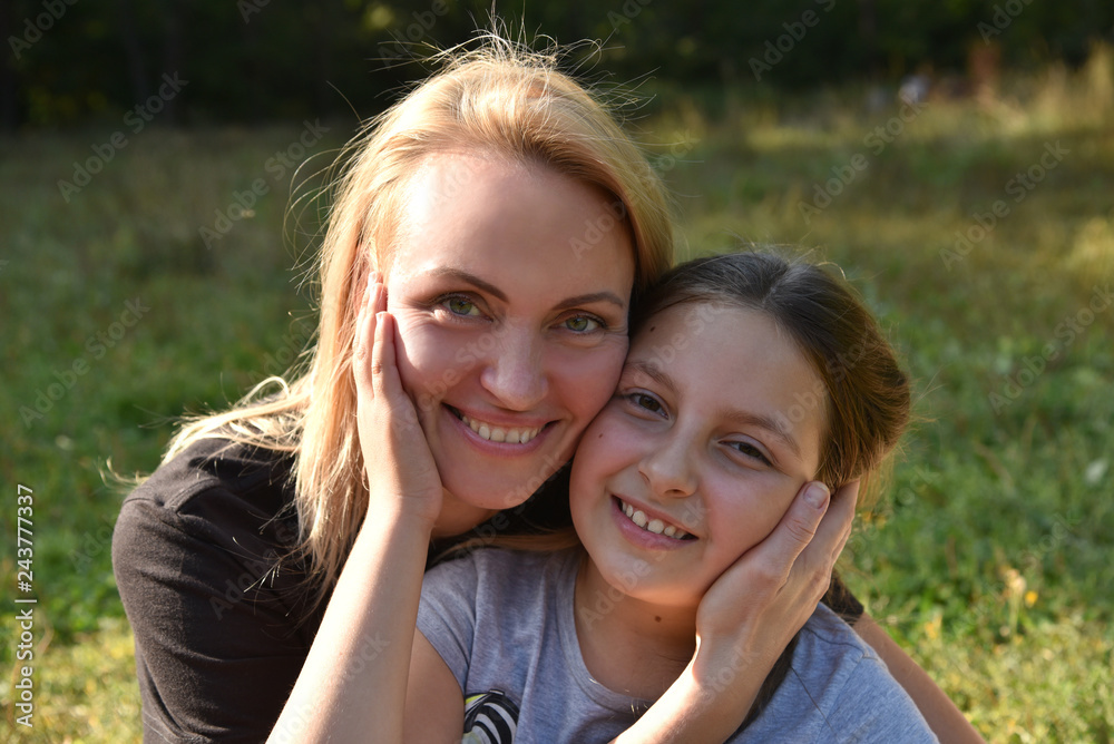 Mother and daughter cheek to cheek in an embrace Mother and daughter cheek to cheek in an embrace