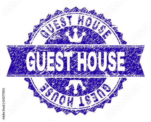 GUEST HOUSE rosette seal overlay with grunge style. Designed with round rosette, ribbon and small crowns. Blue vector rubber watermark of GUEST HOUSE label with corroded style.