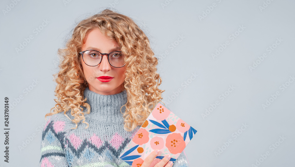 Happy student woman in eyeglasses is reading book Happy student woman in eyeglasses is reading book