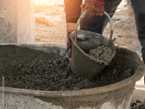 workers scoop the cement at the construction site.