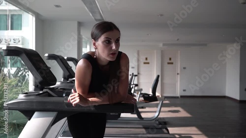 girl is bored and sad in the sport on the treadmill