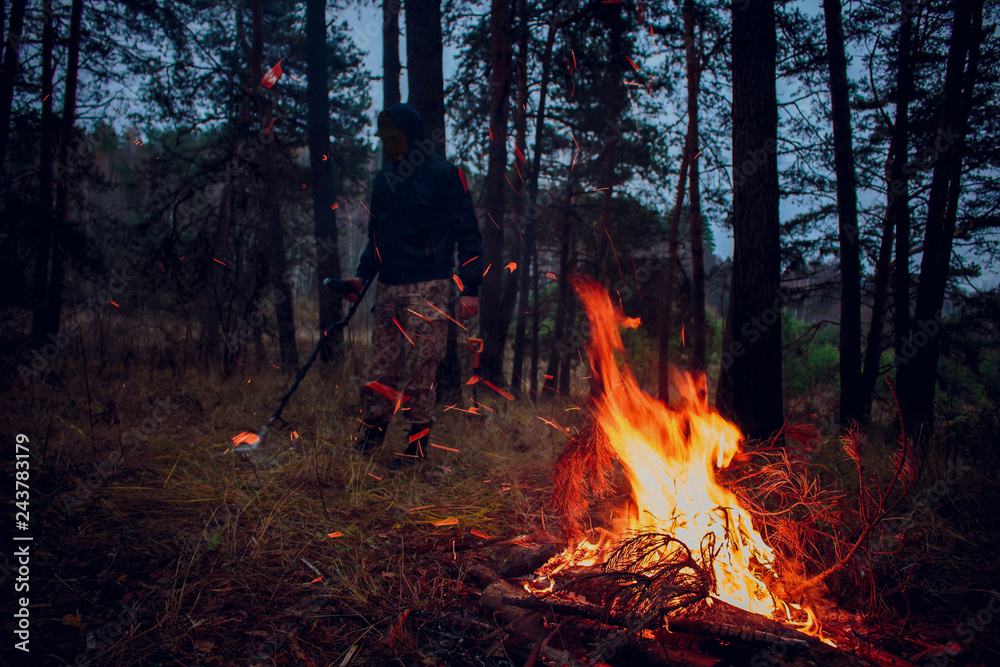 Search with a metal detector in nature, on the background of a fire
Search with a metal detector in nature, on the background of a fire