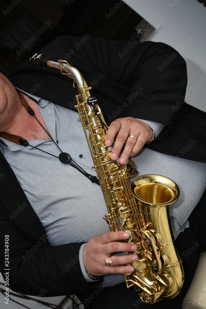 Naklejka premium Man plays the saxophone