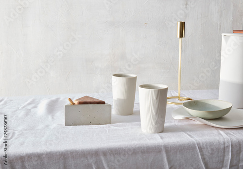 Still life with white ceramics and gold candlestick