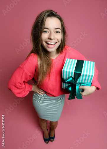 Beautiful woman with shopping presents gift box for happy valentines day on pink  photo