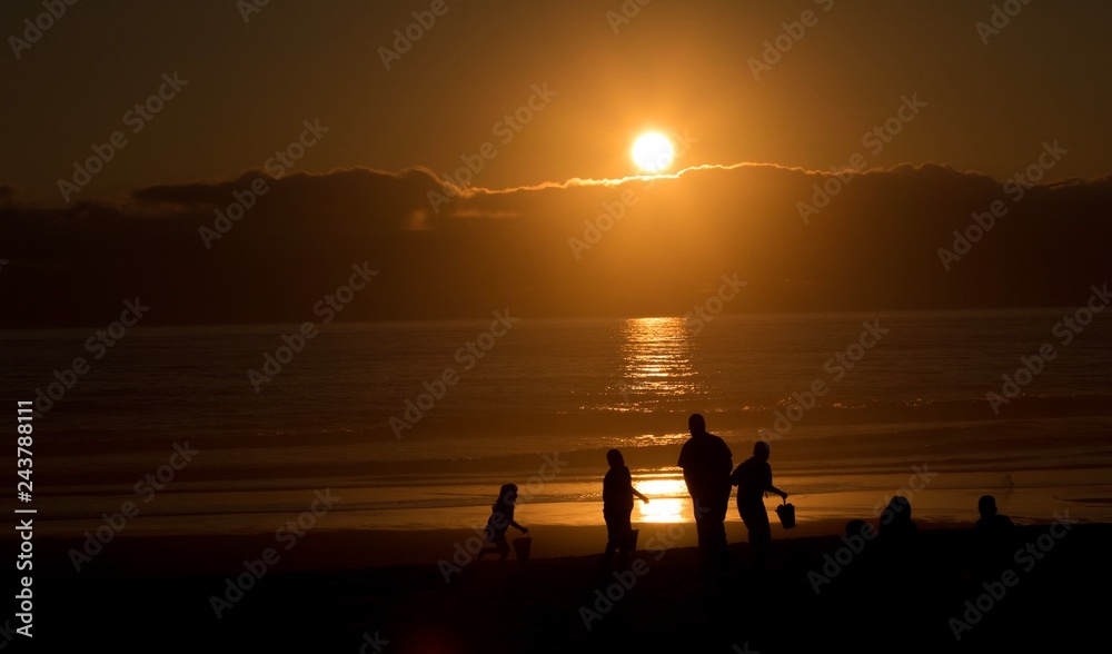 family silhouette on the Beach at sunset