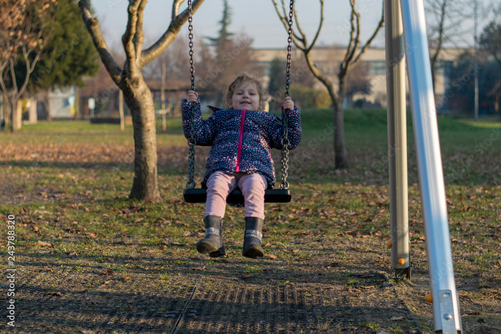 little girl on a swing