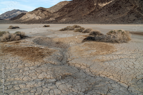 A strange sink hole depression seems to drain water from the surface, Racetrack Playa, Death Valley National Park, California photo